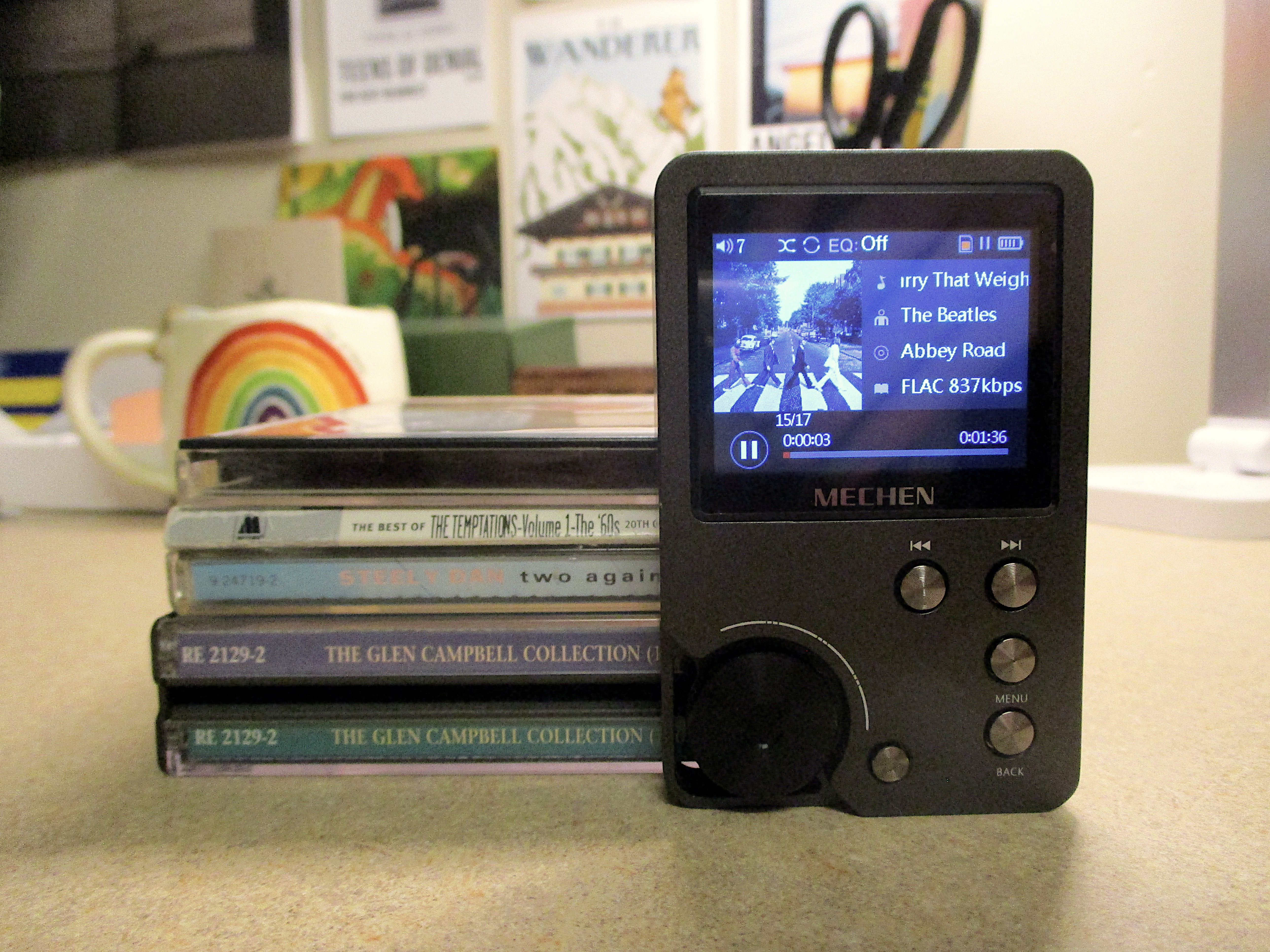 The Mechen M30 next to a stack of CDs.